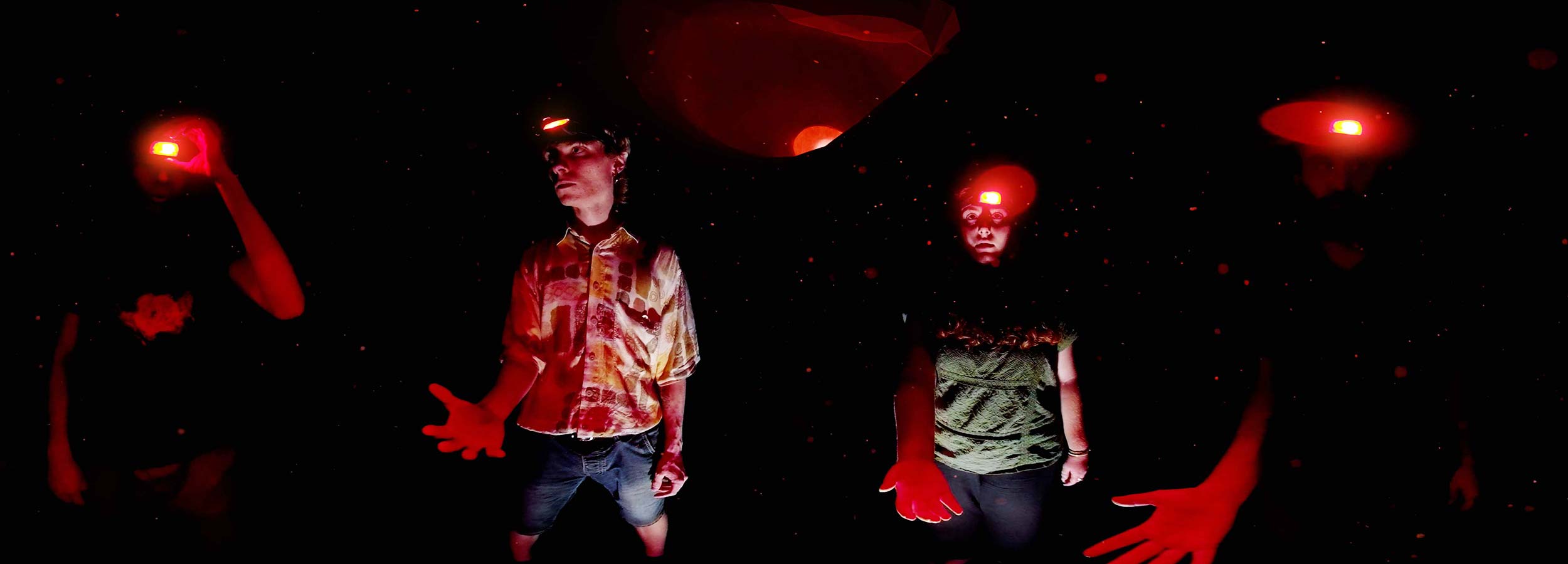 Frame from Dans la Grotte – the students inside the cave debating what to do