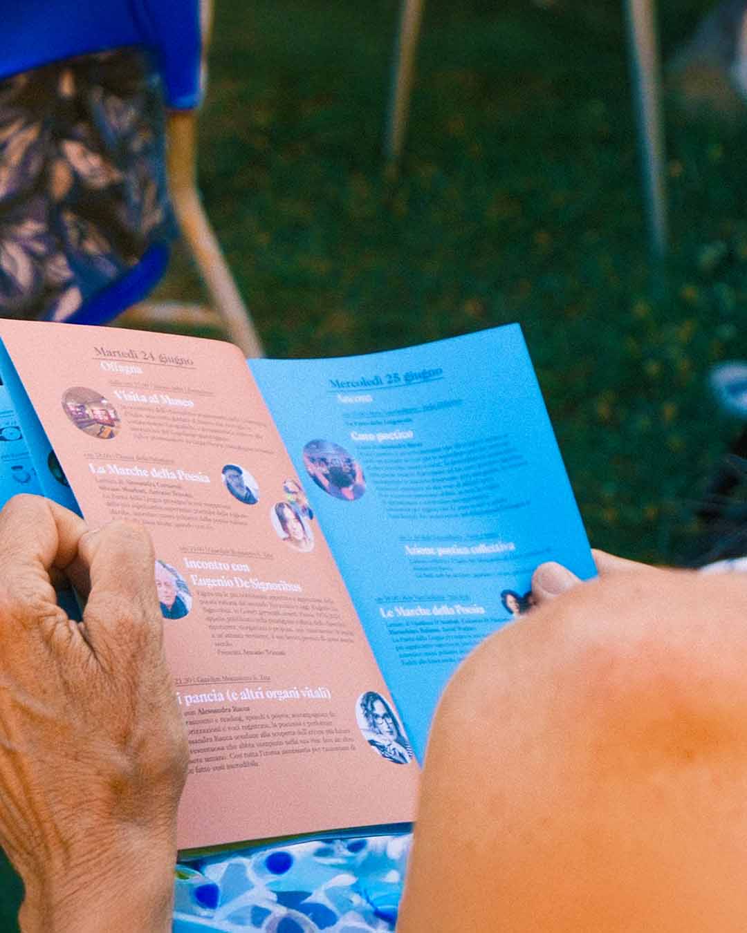 Printed program being browsed by a festival attendee, with visual identity details visible